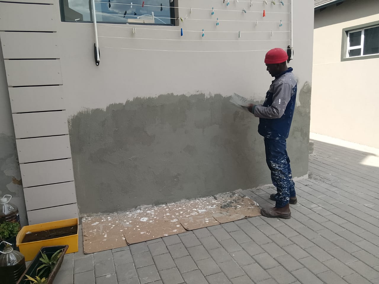 worker plastering part of a wall