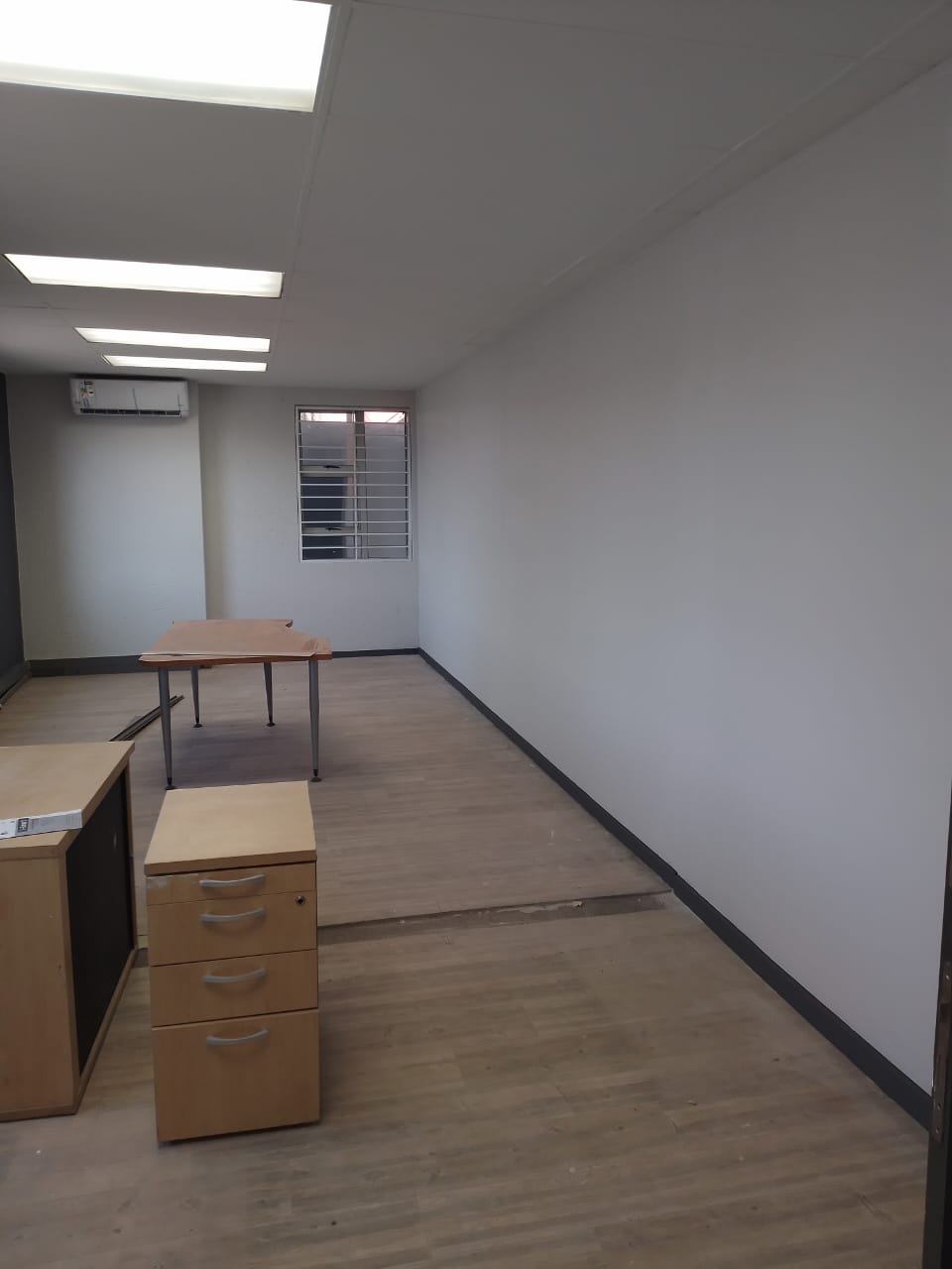 office space with white walls and brown carpet