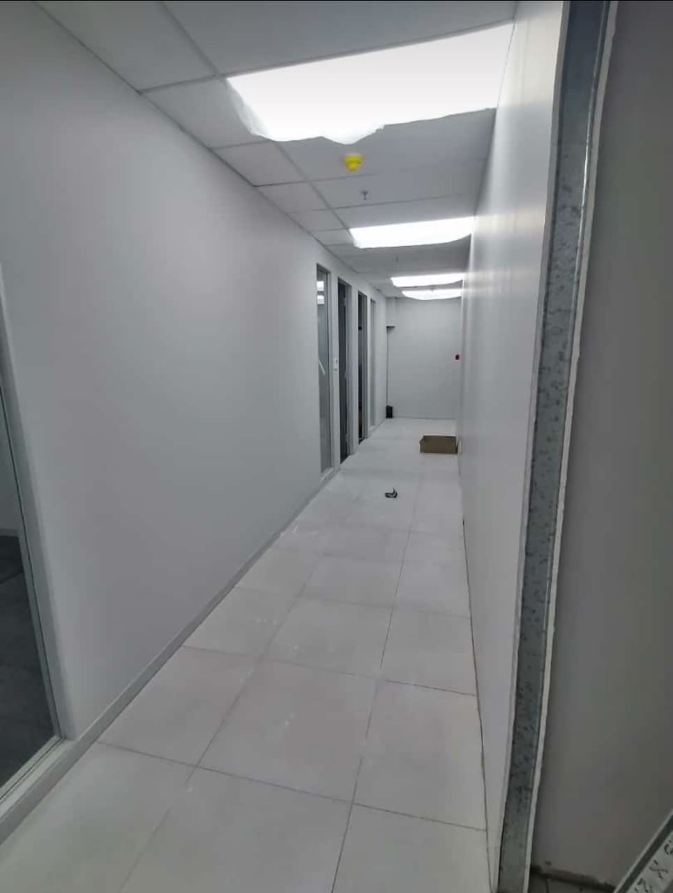 corridor with white walls and white tiles