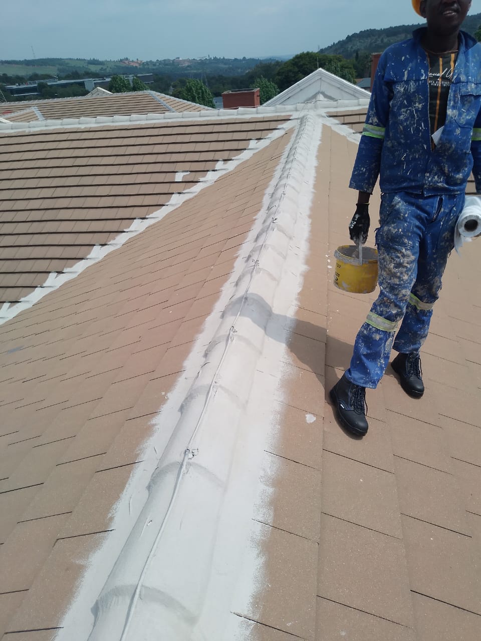 man on roof performin waterproofing